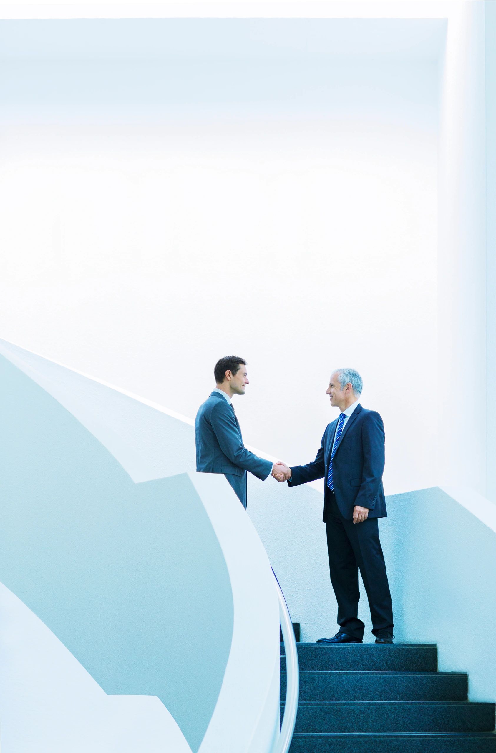 Business owners shaking hands in an office building